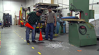 Two men cleaning up glass