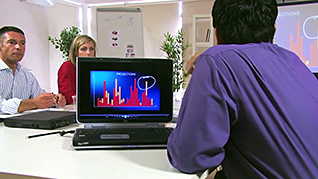 Man looking at graph on computer